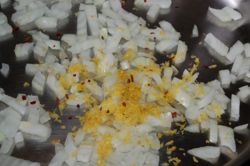 scatter onion, lemon zest and pepper flakes into pan